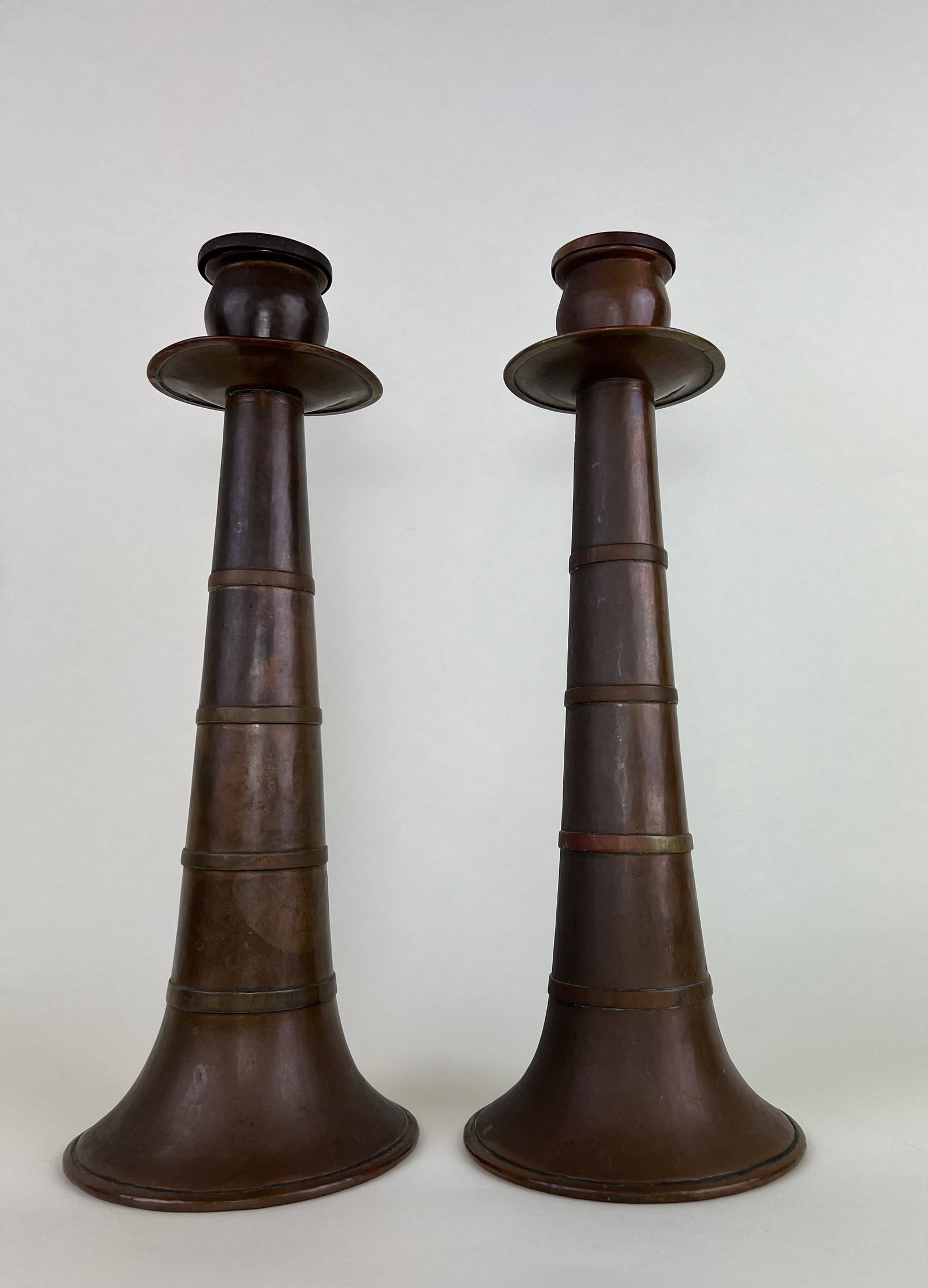 Stickley Bros. Co~ Russian Hand-beaten Copper Candle Sticks~ #131: Stickley Bros. Co~ Russian Hand-beaten Copper Candle Sticks~ Both candle stics are marked ynderside with the numbers 131, matching the picture and number in the catalog. Measures approx. 12 1/2”
