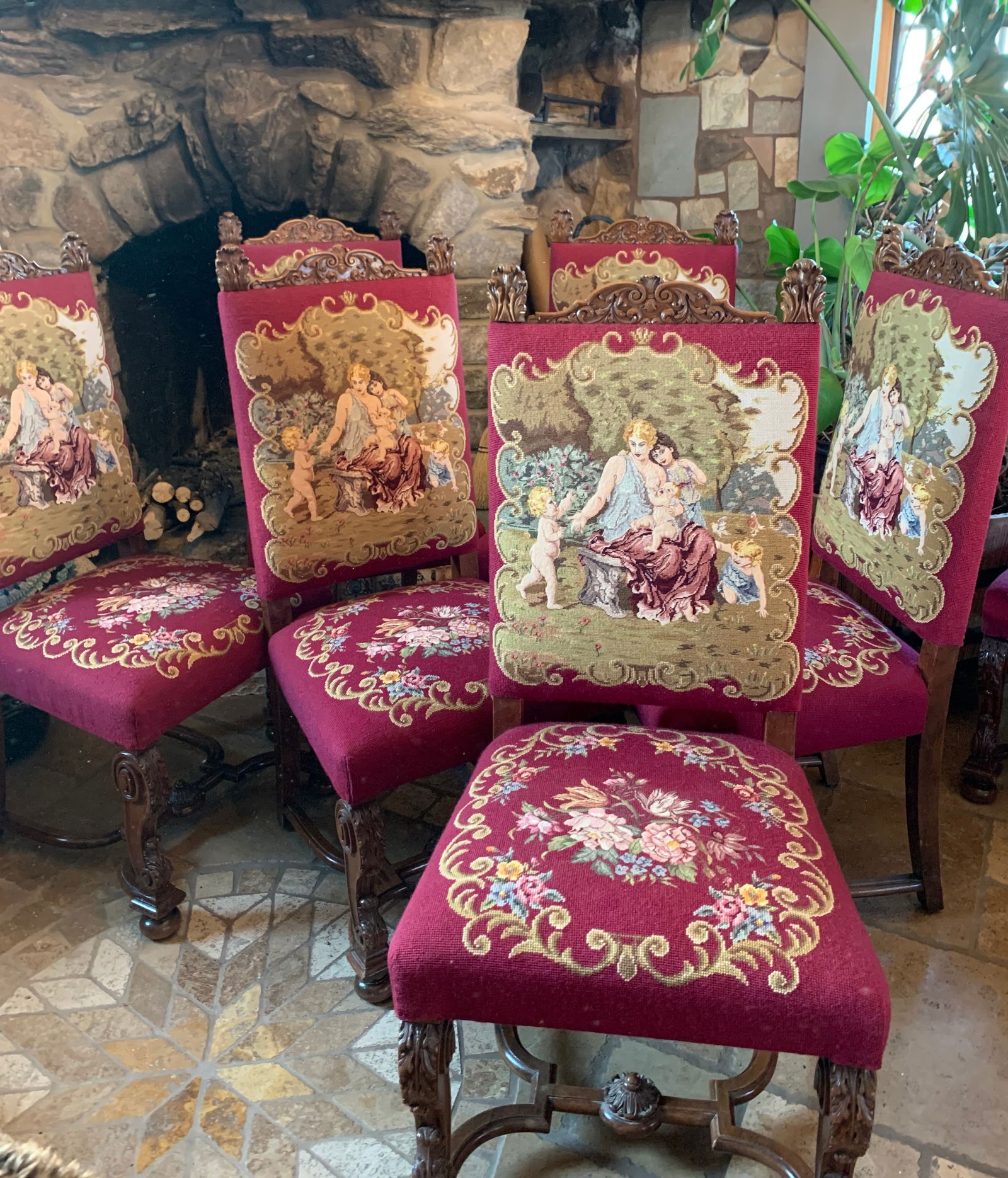 Set of Six Victorian Chairs (English, Late 19th Century) — Needlepoint Upholstered Walnut Seating: This elegant set of six Victorian chairs presents a refined and decorative ensemble, showcasing richly carved walnut frames paired with vibrant needlepoint upholstery. Each chair features a shaped cre