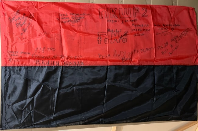 Russian-Ukrainian War Military Memorabilia – Ukrainian Frontline Signed Flag: Title: Ukrainian National Flag with Handwritten Signatures — Frontline Memorial Artifact (Contemporary) Origin: Ukraine Medium: Fabric flag