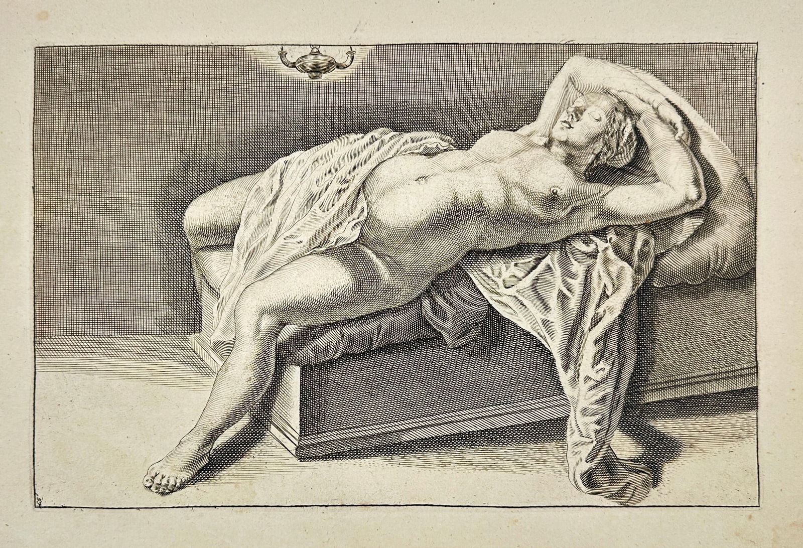 Gérard de Lairesse – Reclining Nude Female Figure – Original Copperplate Engraving: This refined copperplate engraving depicts a reclining nude woman draped in flowing fabric, lying across a low bed with her arms elegantly positioned above her head. The treatment of the figure, light