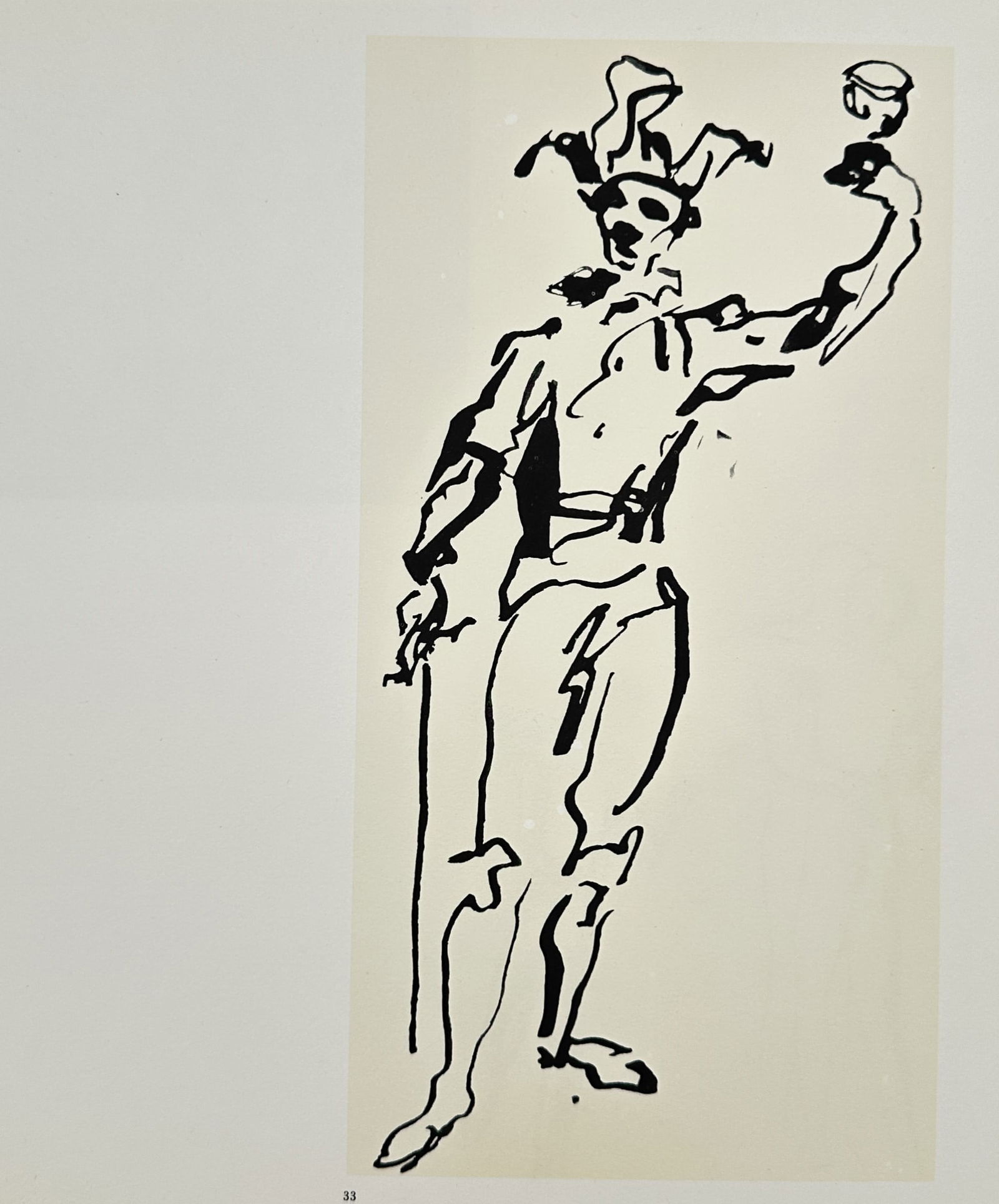 Pablo Picasso (1881–1973), after – Harlequin with a Glass – Offset print (20th Century): "Harlequin with a Glass" is an offset print depicting a standing figure in traditional commedia dell'arte attire, including a bicorn hat with bells and a multi-colored diamond-patterned costume. The f