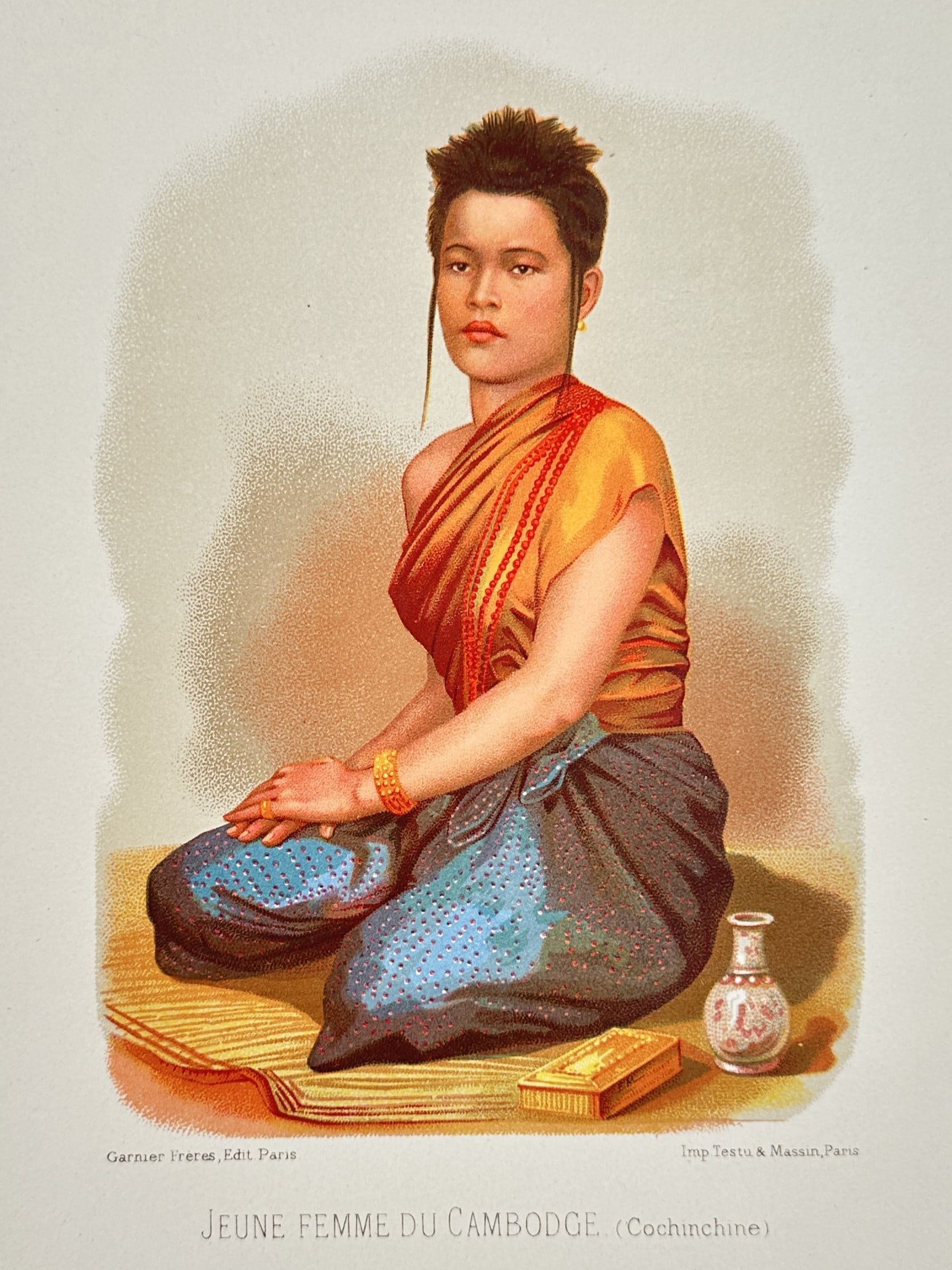 Testu & Massin (Active 19th Century) – Portrait of a Young Woman from Cambodia: "Jeune Femme du Cambodge (Cochinchine)" is a chromolithograph featuring a full-length portrait of a Cambodian woman seated on a woven mat. The subject is depicted in traditional attire, wearing a drap