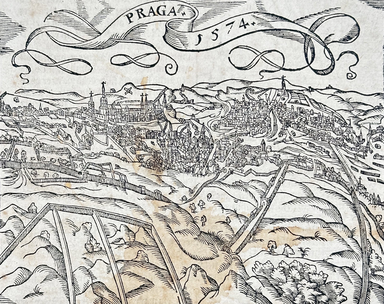 Sebastian Münster (1488-1552) – View of Prague – Czech Republic – Woodcut (1574): "Praga." This woodcut view of Prague is from an edition of the Cosmographia, a monumental geographic and historical work by Sebastian Münster. The publication was produced by the officina of Heinrich