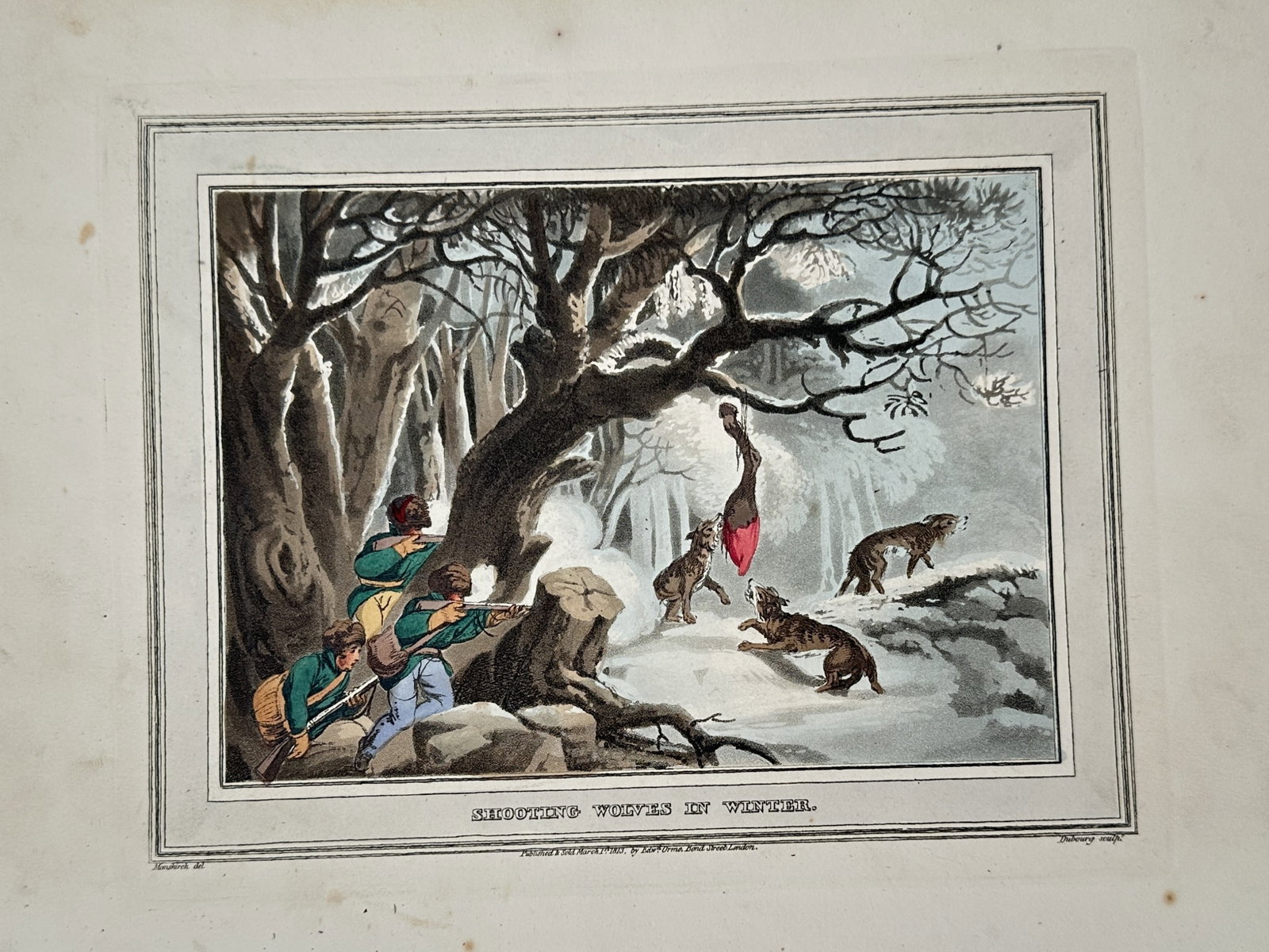 John Heaviside Clark (1771-1863) – View of Shooting Wolves in Winter – Hand-coloured aquatint: "Shooting Wolves in Winter" portrays hunters positioned behind a tree in a snow-covered forest, aiming their rifles at a pack of wolves attracted to a carcass hanging from a branch. This hand-coloured