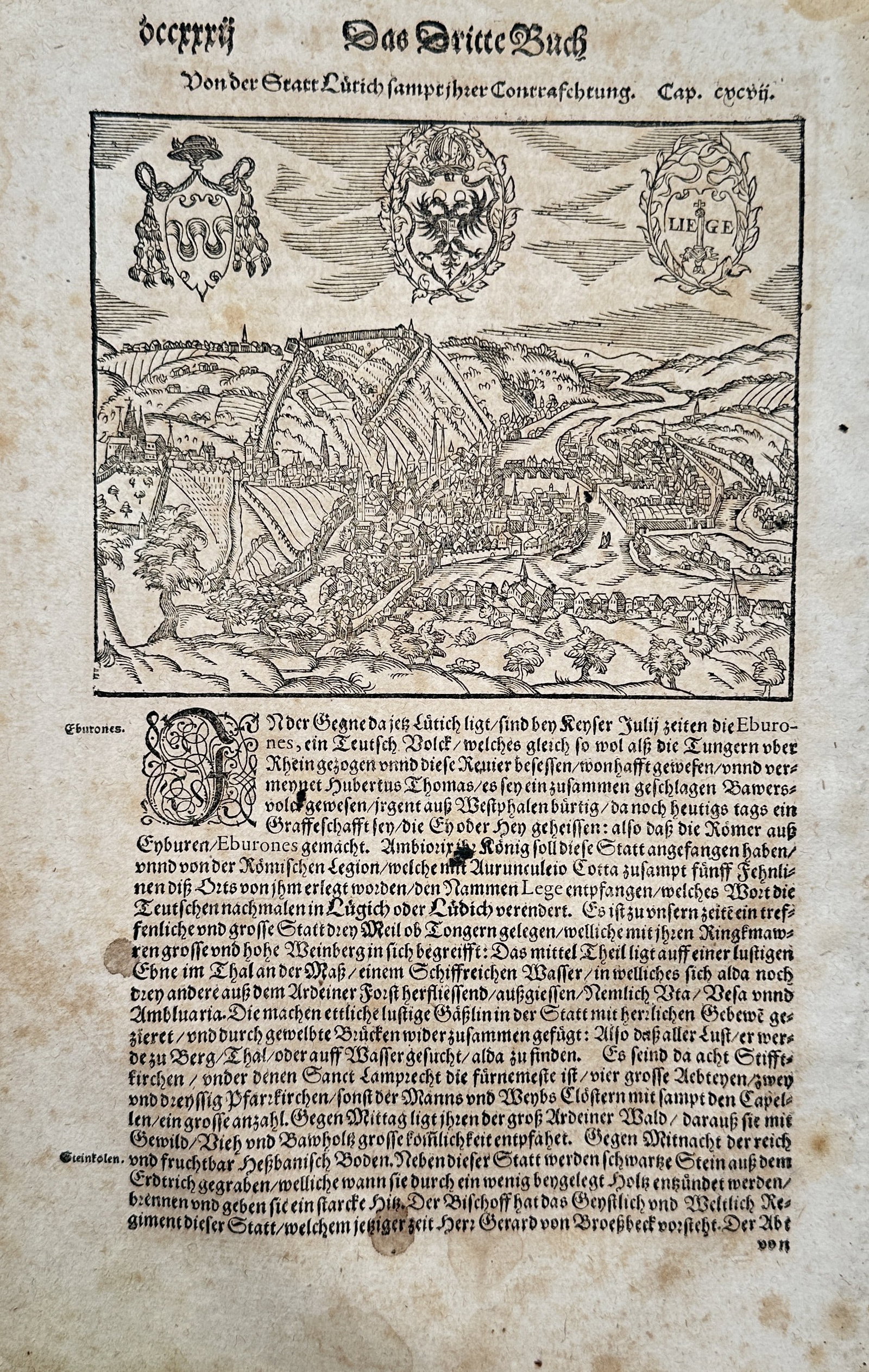 Sebastian Münster (1488–1552) – View and Coat of Arms of Liège – Woodcut (c. 1550): "Von der Statt Lüttich Sampt ihrer Contrafrahtung" illustrates a broad overview of a historical cityscape and territorial view of the city of Liège. The composition features a landscape layout showi