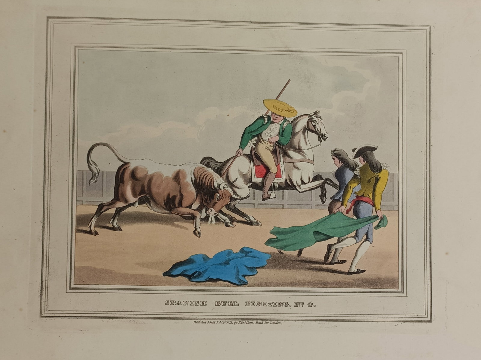 John Heaviside Clark (ca. 1771–1863) – Spanish Bull Fighting – Hand-coloured aquatint (1813): "Spanish Bull Fighting" features a dynamic sporting scene documenting a traditional bullfight within an arena setting enclosed by a rectangular border. The composition displays an intense confrontatio