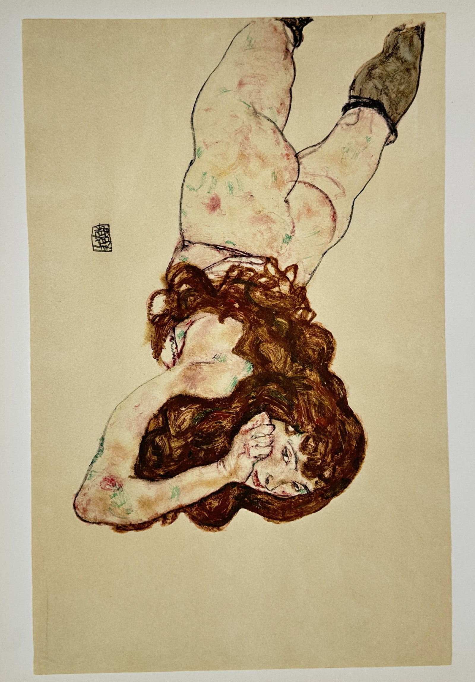 Egon Schiele, after – Reclining Woman – Offset print (20th Century): "Reclining Woman" presents a broad overview of a reclining female figure with long, dark hair resting her head on her hand against an isolated background. This expressionist figurative study focuses o