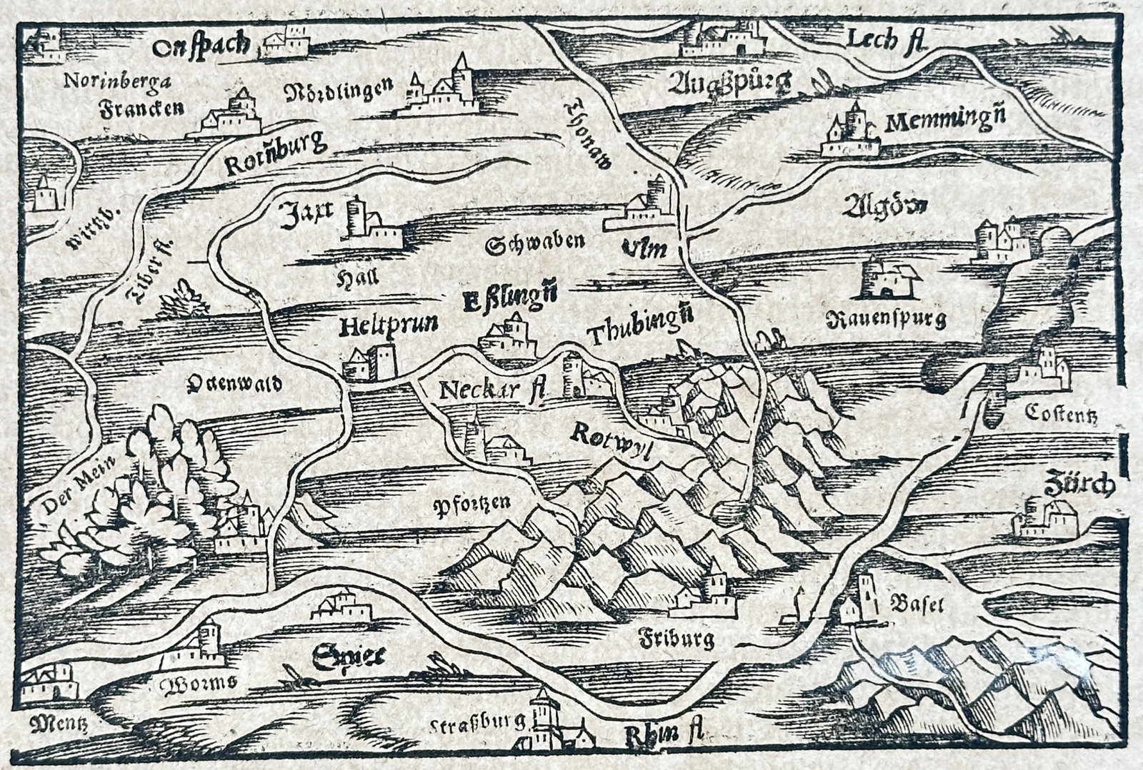 Sebastian Münster – View of Swabia – Germany – Woodcut (16th Century): "Das Dritte Buch" This cartographic woodcut features a regional map of Swabia in southern Germany, detailing the local topography, surrounding mountain ranges, and major river basins. The educational 