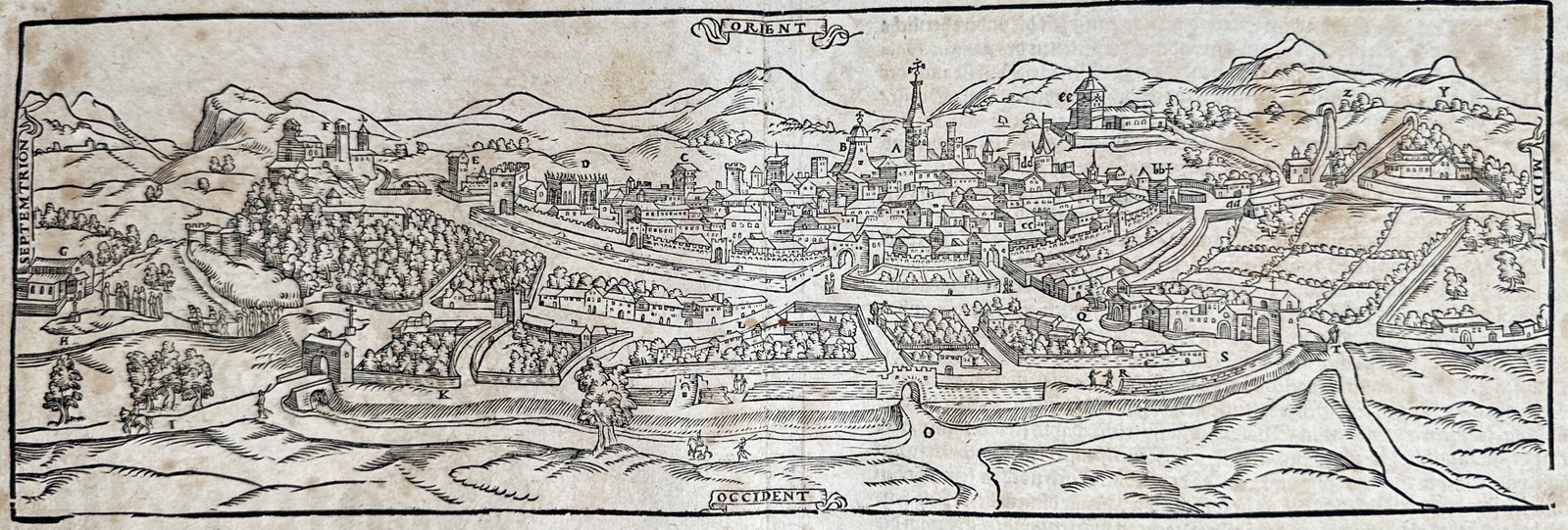 Sebastian Münster – Map of Montpellier – France – Woodcut (16th Century): "The City of Montpellier with Its Surroundings" presents a panoramic bird's-eye topographical view depicting the city of Montpellier surrounded by rolling hills, fields, fortifications, and prominent 