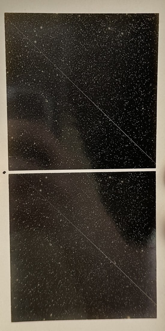 Max Wolf – A Shooting Star in Andromeda – Lithograph (20th Century): "A Shooting Star" presents a pair of stereoscopic astronomical photographs capturing the luminous streak of a meteor traversing the star field in the constellation Andromeda. The scientific plates dem