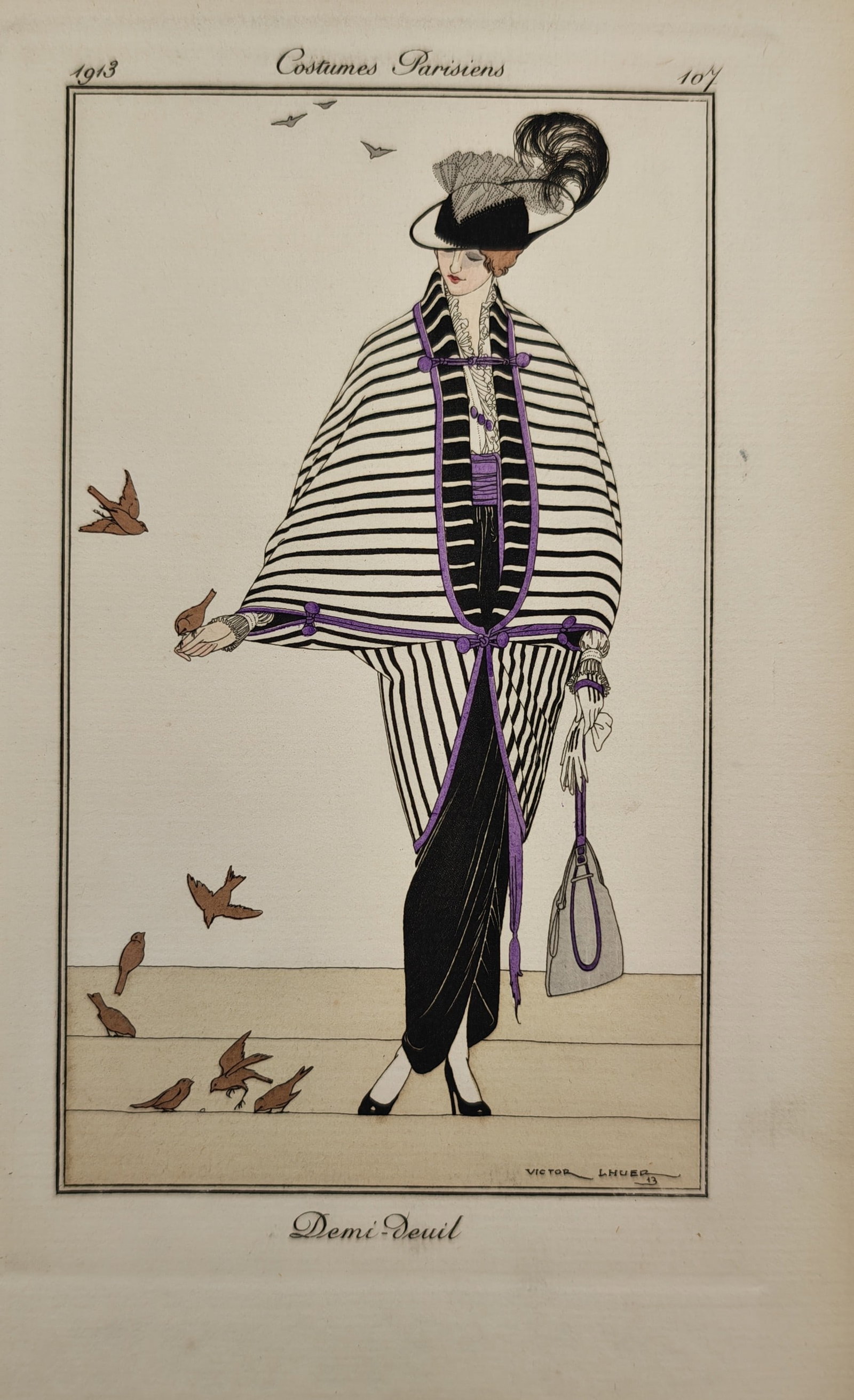 Victor Lhuer – Half Mourning – Pochoir Print (1913): "Demi-Deuil" This fashion print presents a full-length portrait of a woman standing outdoors while feeding small birds, showcasing a striking black and white striped cape outfit accented with purple r
