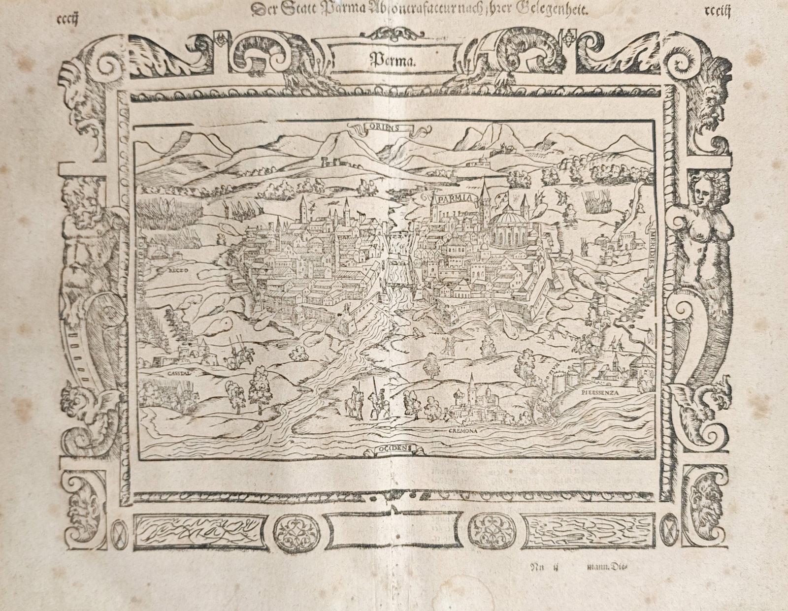Sebastian Münster – Map of Parma – Italy – Woodcut (1550): "Depiction of the City of Parma According to Its Situation" presents a panoramic bird's-eye view of the fortified Italian city and its surrounding landscape, enclosed within an elaborate strapwork bor