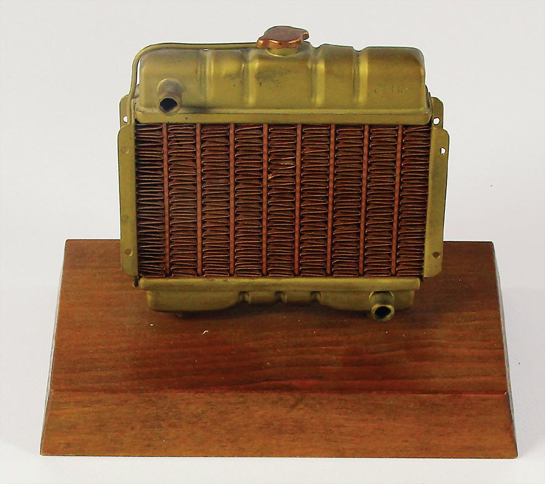 BEHR model of a radiator on a wood base, c. 12cm x: BEHR model of a radiator on a wood base, c. 12cm x 12cm. German Description BEHR Modell eines Kühlers auf Holzsockel, ca. 12cm x 12cm.