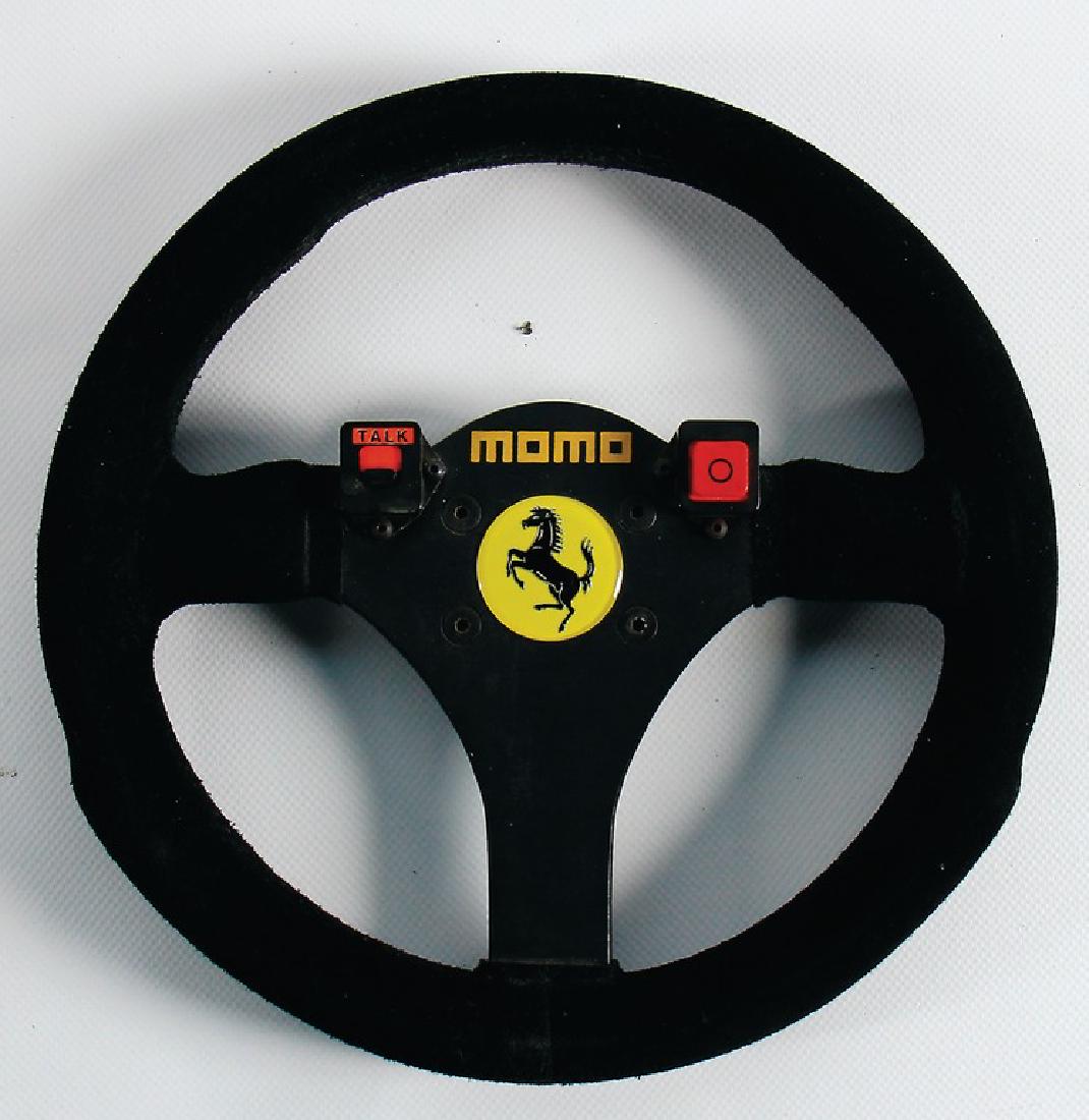 FERRARI/MOMO F1-steering wheel replika of the: FERRARI/MOMO F1-steering wheel replika of the manufacturer Momo, for Ferrari 642F1 1991, with a diameter of 26cm, good condition German Description FERRARI/MOMO F1-Lenkrad Replika vom Hersteller Momo,