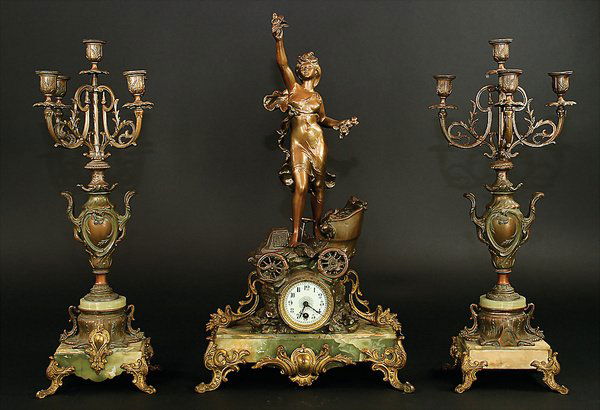 clock for fireplace, tin coated with bronze, sign: English Description: clock for fireplace, tin coated with bronze, signed Moreau, around 1900, woman with waving clothes and reach out arm, on a automobile, on marble base, with gold application, cloc
