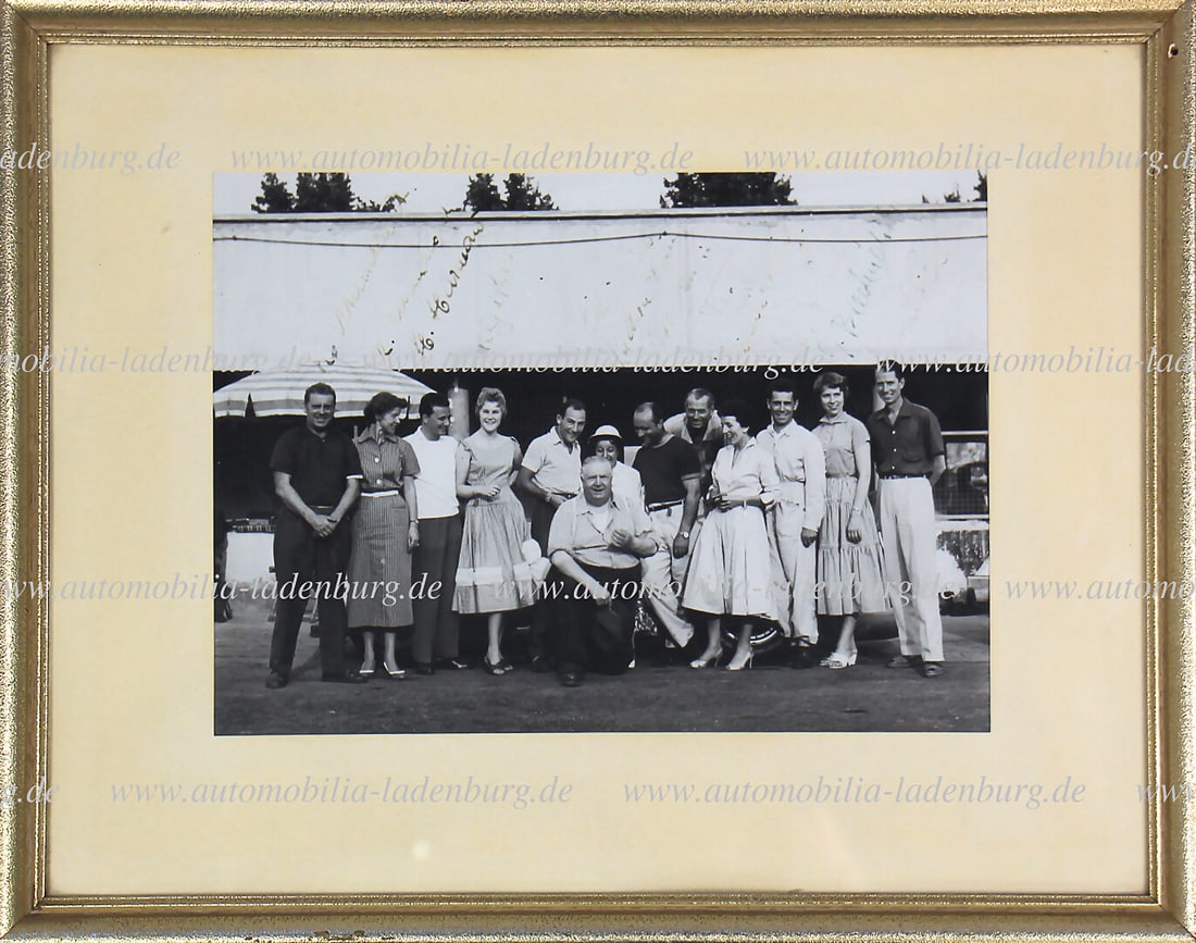 HANS HERRMANN Hand-signed framed original b/w photograph, Mercedes Benz racing team 1955, signed by: HANS HERRMANN Hand-signed framed original b/w photograph, Mercedes Benz racing team 1955, signed by Rudolf Uhlenhaut, Mrs. Uhlenhaut, Hans Herrmann and girlfriend Helga, Stirling Moss, Juan Manuel Fan