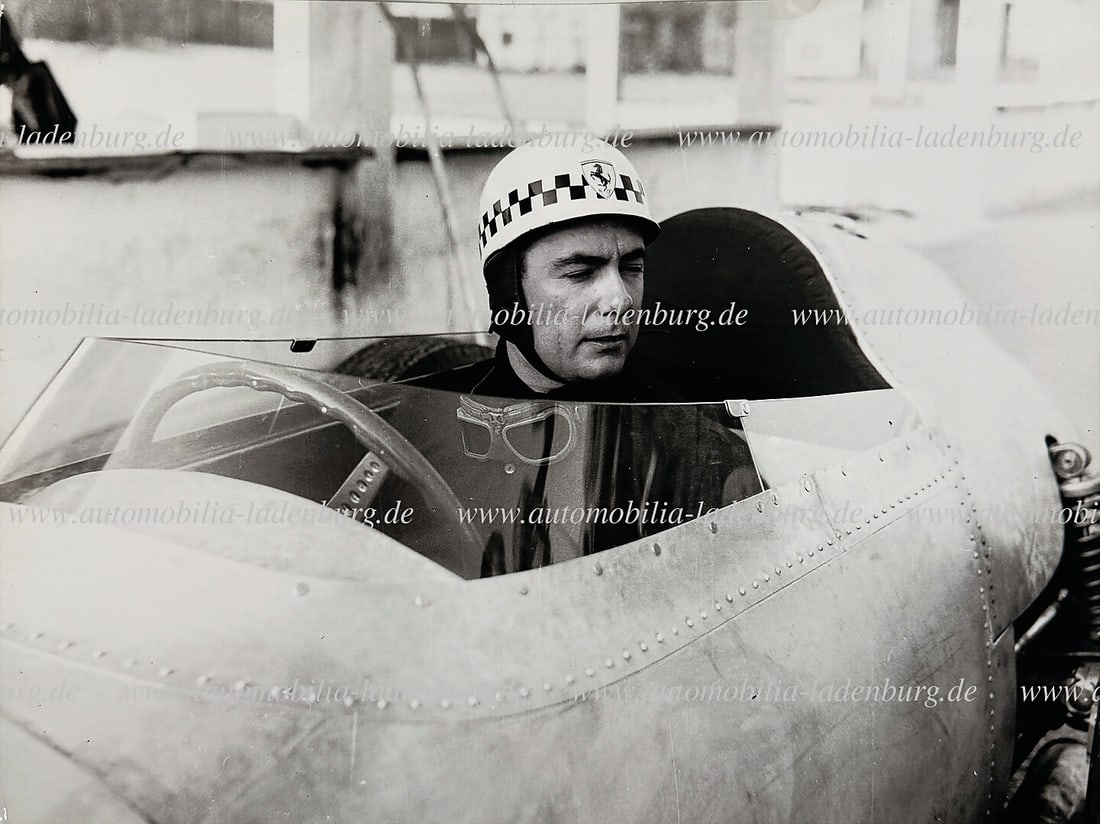 FERRARI original b/w photo Jean Behra in the cockpit of the Ferrari 246 Dino F1, (unpainted car),: FERRARI original b/w photo Jean Behra in the cockpit of the Ferrari 246 Dino F1, (unpainted car), during test drives in Modena 1959, 18x24cm, stamped "Foto Coltrin German Description FERRARI original 