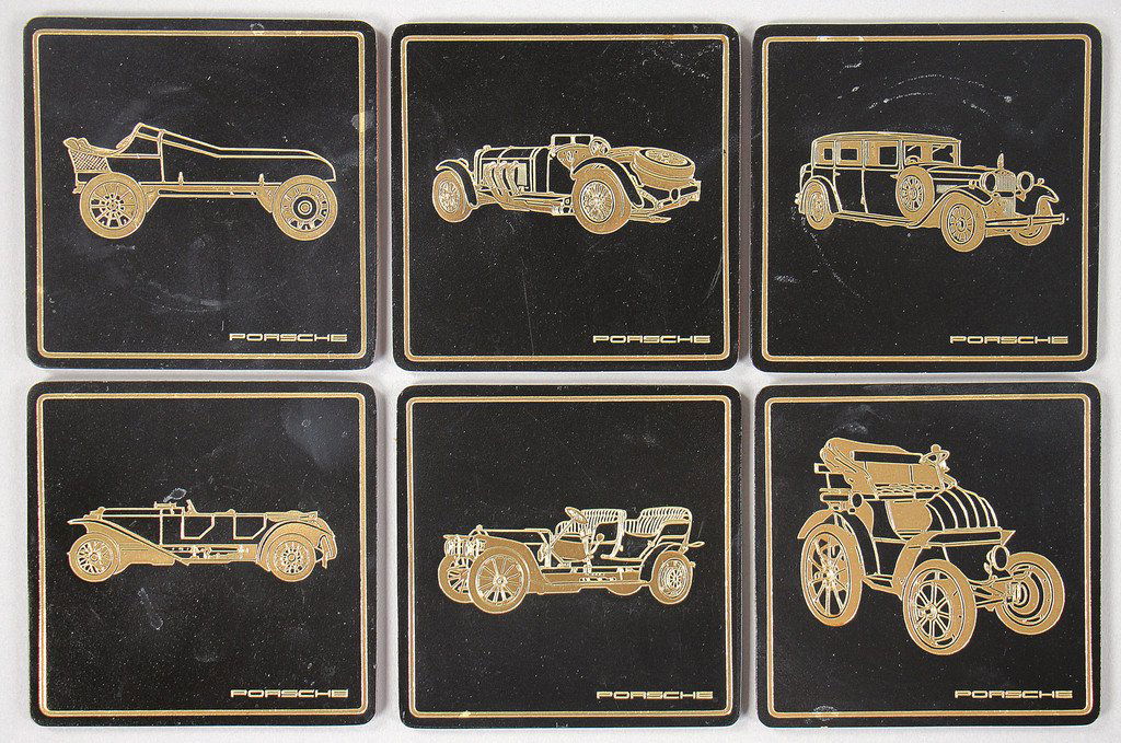 PORSCHE 6 glass coasters, covered with leather with: PORSCHE 6 glass coasters, covered with leather with motifs of Porsche vehicles, good condition German Description PORSCHE 6 mal Gläseruntersetzer, Lederbezogen mit Porsche Konstruktionsmotiven, guter