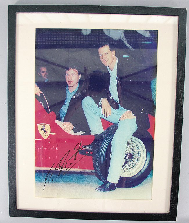 FERRARI Original color photo of Michael Schumacher and: FERRARI Original color photo of Michael Schumacher and Eddie Irvine in a Ferrari Monoposto racing car, autographed, original by Michael Schumacher, format 53x43 cm, in a wooden frame, good condition G