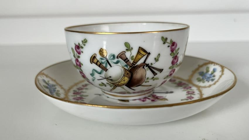 XVIII Century Sevres porcelain cup and saucer.Vincennes PORCELAIN: Vincennes Porcelain Cup And Saucer Tea cup with saucer, Sèvres (France), 1757. polychrome, floral painting and gold decoration depicting music instruments.Most likely made for an Ottoman market.