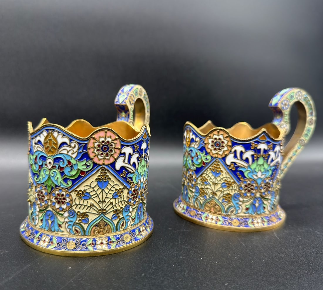 Pair of Russian Silver Enamel glass holders,20 Artel: Very unusual pair of Russian Old Silver gilt cloisonné enamel glass holders decorated with very beautiful details.Condition: Very good.Measures: 9,5cm high; 7,3cm wide;Marks: 20A, 88 with kokoshnik