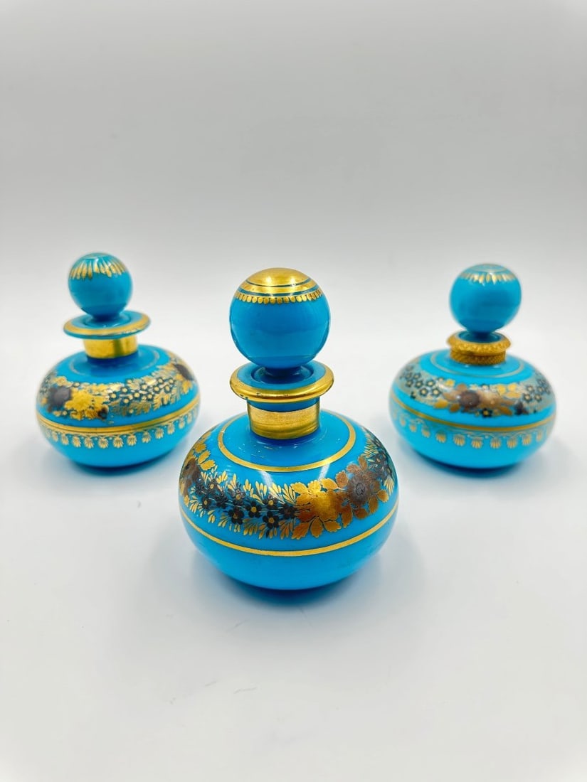 Set of three turquoise blue opaline bottles with painted decoration of golden auts flowers. (1 of 13)