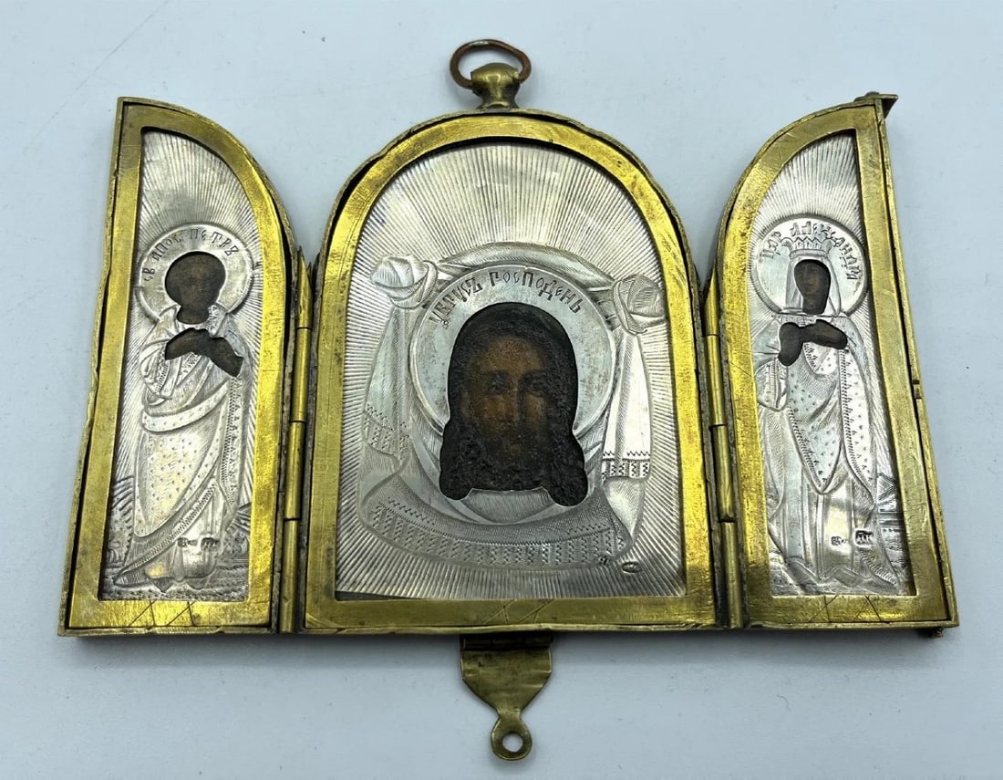 19th Century Russian Silver Triptych Travelling Icon St Alexandra And St Apostle Peter,our Savi: Standart 84 zolotnik.Before 1908 left facing woman's head in profile within an oval cartoucheSilversmiths initials for H.K for Nikolay Kemper (St. Petersburg 1898-1908)Assayer marks:I.L. For Ivan Lebe