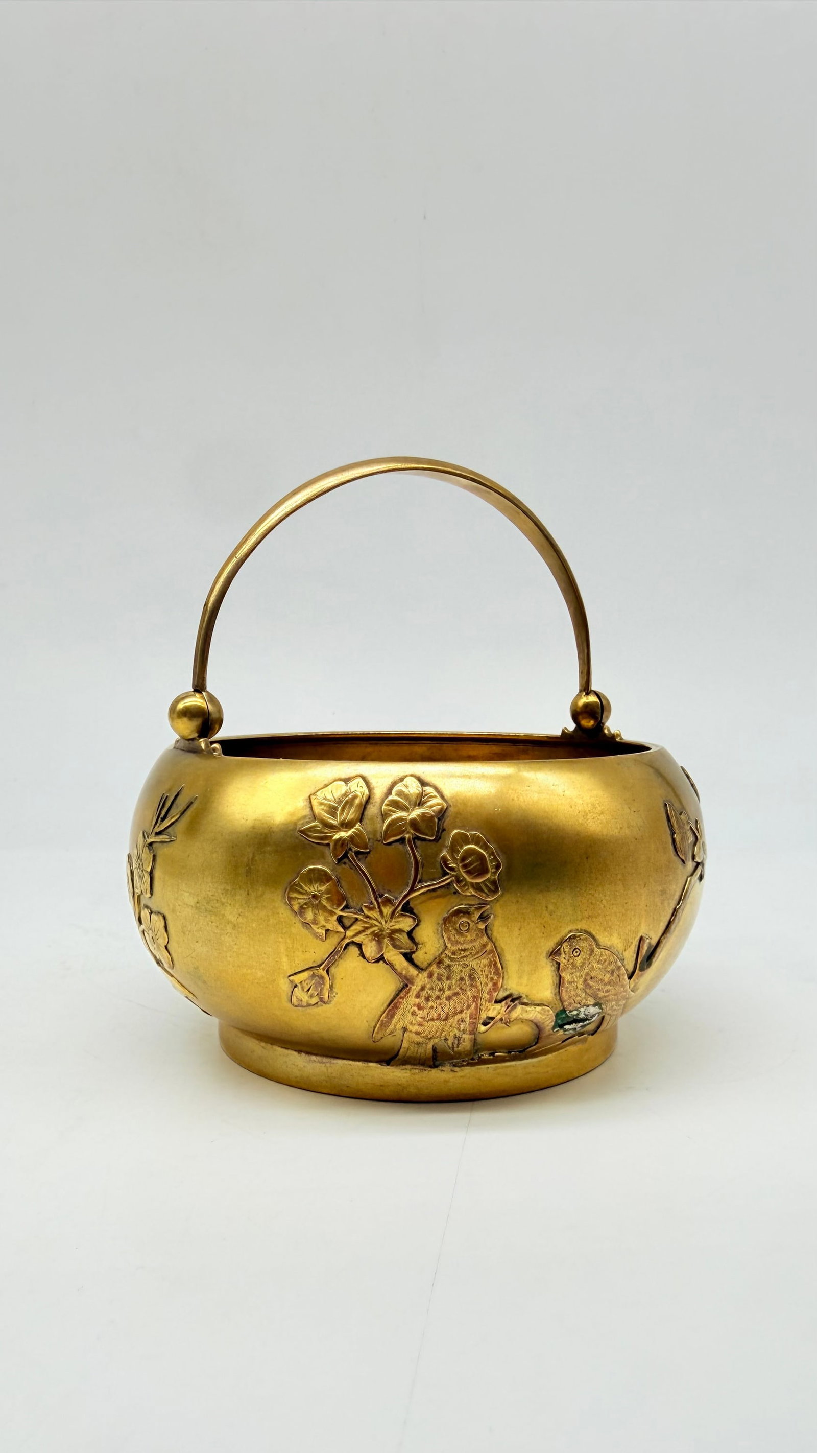 A Russian Imperial Silver-Gilt and Chased Japonist Sugar Bowl by Pavel Ovchinnikov, Moscow, 1893: Pavel OVCHINNIKOV (1830–1888)Vermeil silver sugar bowl (84 zolotniks gilt silver) of bulbous form with an articulated movable handle, with chased relief decoration in a Japonist style of a vegetal m