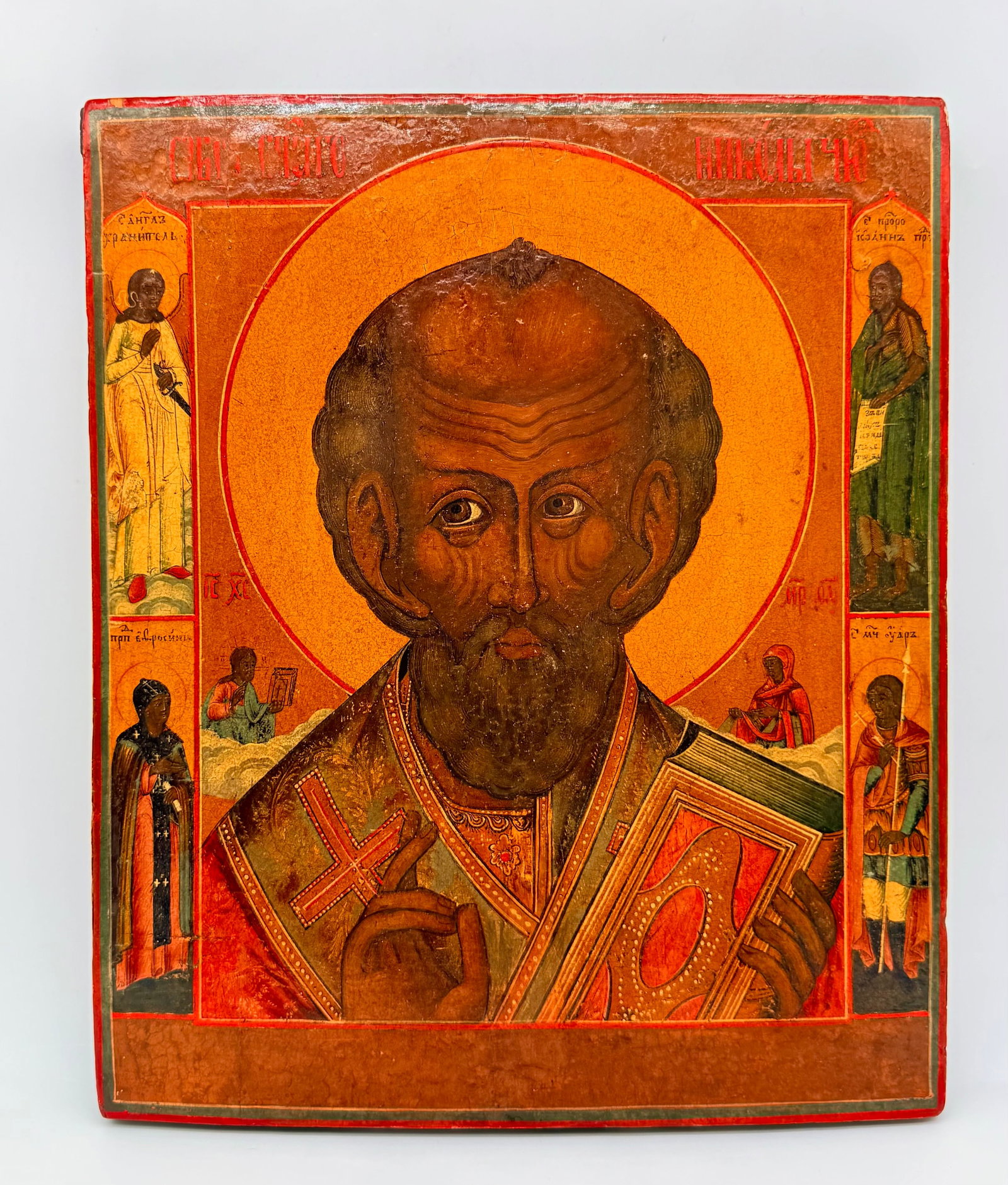 Icon Of Saint Nicholas The Wonderworker, Tempera And Gilt Wood Panel, Russia, 19th Century: Russian School, 19th Century. An icon depicting Saint Nicholas the Wonderworker (Saint Nicholas of Myra) in a bust portrait, blessing with his right hand and holding the Book of the Gospels in his lef