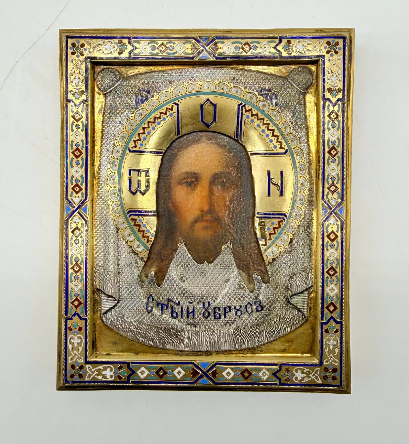 Icon of Christ The Savior Not Made by Hands or the miraculous Mandylion.Icon,champleve enamel.1889: Moscow School of the 19th Century.Icon of Christ Acheiropoietos (Mandylion or Holy Shroud – Spas Nerukotvorny).Tempera on wooden panel with oklad (riza) in gilt silver and polychrome cloisonné and 