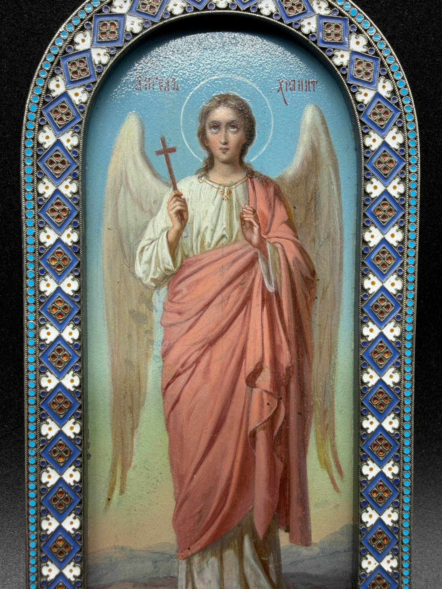 Pavel Ovchinnikov, Guardian Angel Icon, Moscow, circa 1880–1890, in silver and enamel: Pavel OVCHINNIKOV (1830–1888)Guardian Angel Icon (????? ?????????).Painted plaque set in a curved oklad in 84 zolotniks silver (875/1000), gilded and polychrome cloisonné enamel.Moscow, late 19th c