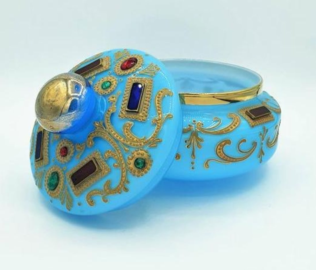 TURQUOISE OPALINE GLASS AND JEWELED CANDY BOX FOR THE OTTOMAN MARKET, 19TH CENTURY: A large covered candy dish (bonbonnière) of squat circular form with a fitted domed lid topped by a spherical gilt knob finial, crafted in vibrant turquoise opaline glass. Elaborately embellished wit