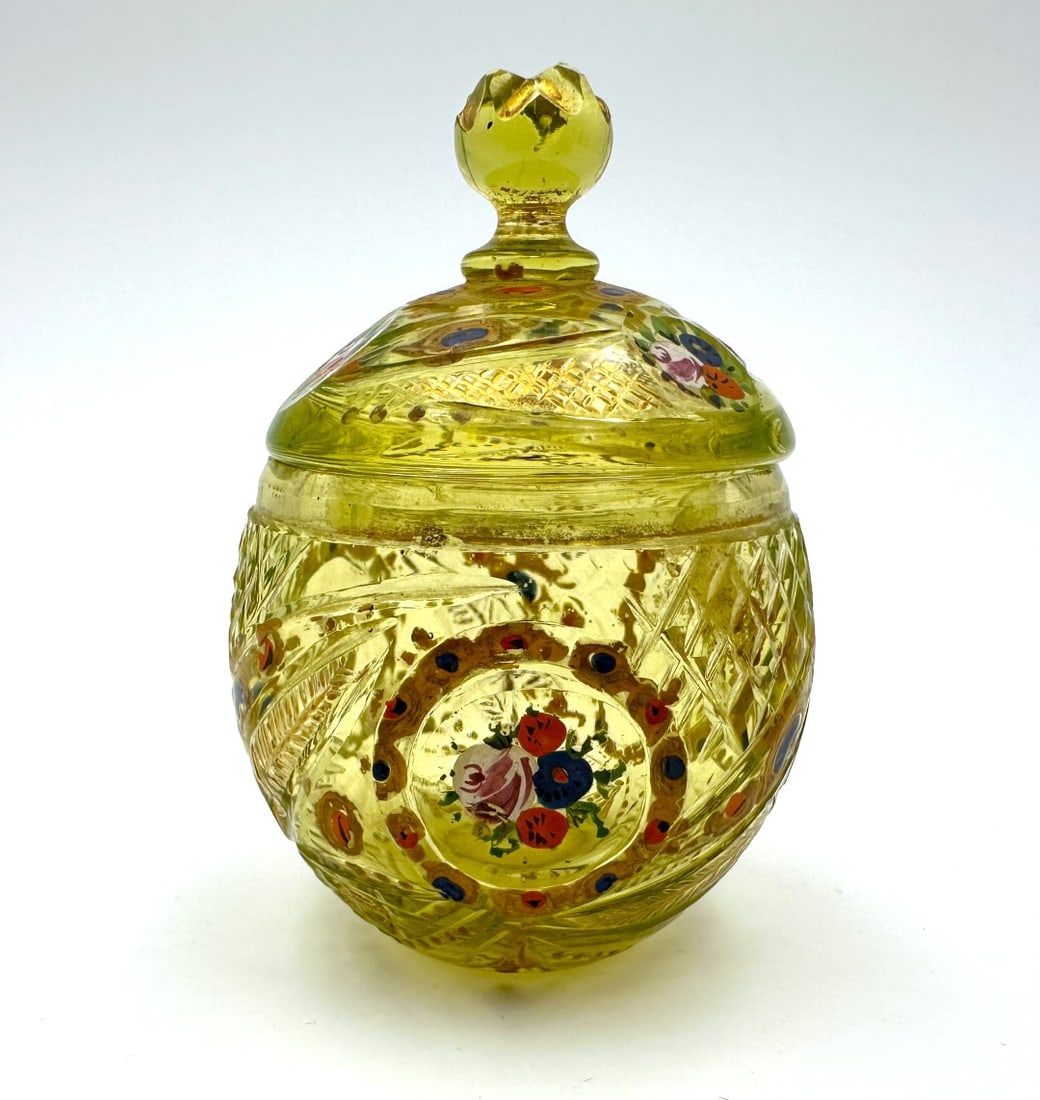 BOHEMIAN ENAMELED URANIUM GLASS CANDY DISH FOR THE OTTOMAN MARKET, 19TH CENTURY: A covered candy dish (bonbonnière) of ovoid form, crafted in distinctive yellow-green uranium glass (Annagrün) with a fitted domed lid surmounted by a facet-cut finial. Expertly wheel-cut with diamo