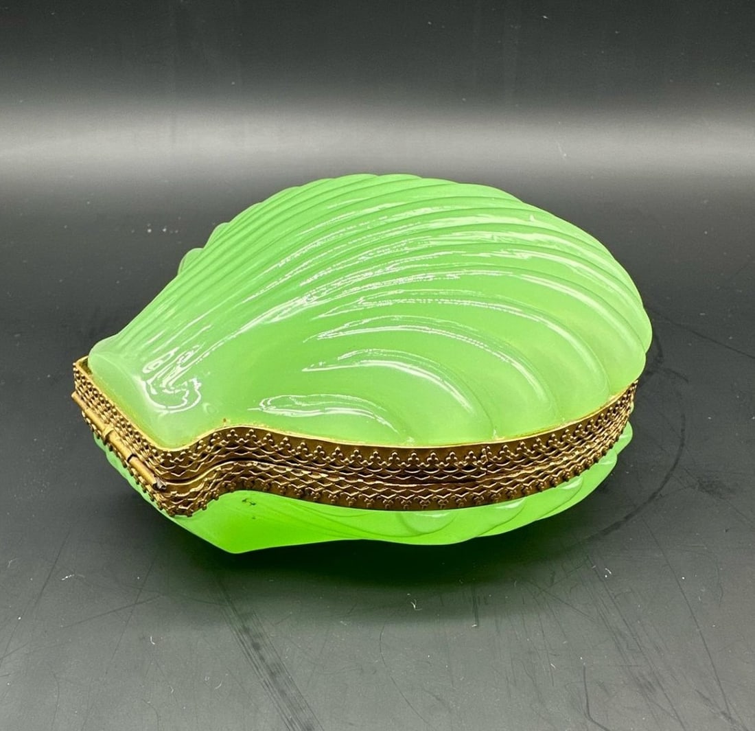 FRENCH GILT-BRONZE MOUNTED GREEN OPALINE GLASS SHELL-FORM BOX, NAPOLEON III PERIOD, 19TH CENTURY: Jewelry box crafted in vibrant apple-green opaline glass, beautifully press-molded in the organic shape of a scallop shell with delicate ribbed fluting. The two hinged halves are joined by an ornate g