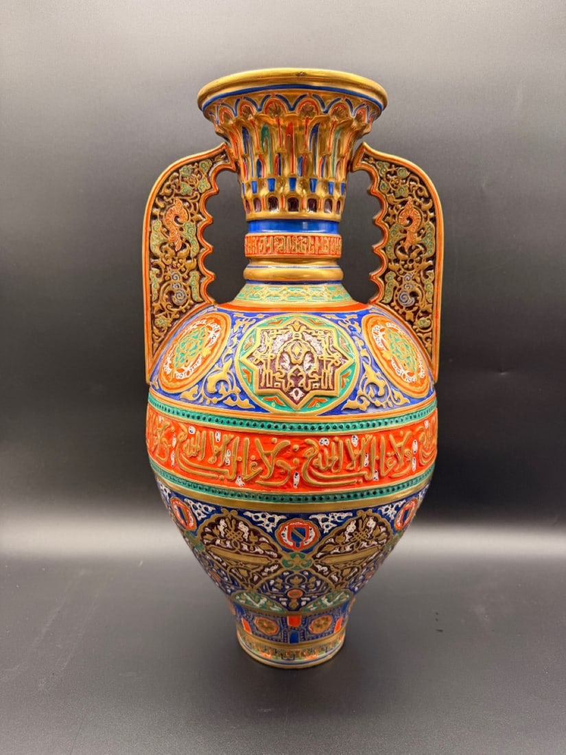 LARGE HISPANO-MORESQUE STYLE ALHAMBRA VASE, 19TH CENTURY: A porcelain vase inspired by 14th-century Nasrid ceramics from the Alhambra palace. The vessel features a bulbous body, a flared neck with molded stalactite motifs, and two wing-shaped handles with op