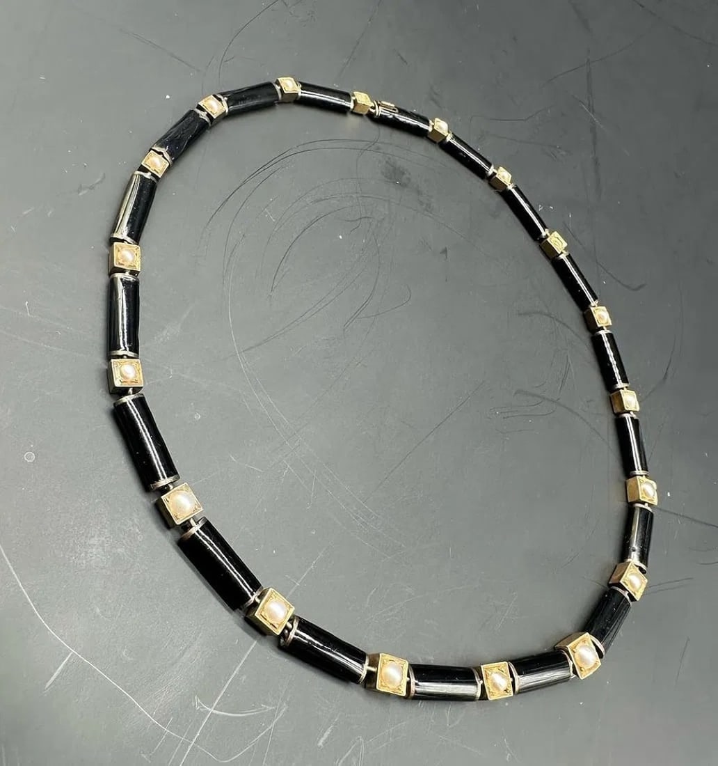 Art Deco 18K rose gold, black enamel and natural saltwater pearl necklace: Choker necklace composed of alternating tubular 18K rose gold elements coated in glossy black enamel, and natural saltwater pearls set within square 18K rose gold openwork spacers featuring geometric 