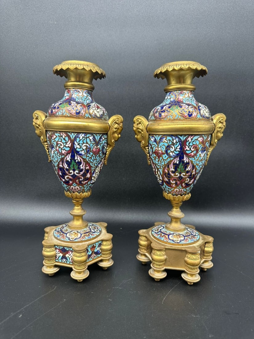 PAIR OF FRENCH GILT-BRONZE AND CHAMPLEVÉ ENAMEL VASES, LATE 19TH CENTURY: A fine pair of French urn-form vases in gilded bronze (ormolu) and vibrant polychrome champlevé enamel. Each vessel features a flared acanthus-leaf rim above an amphora-shaped body decorated with den