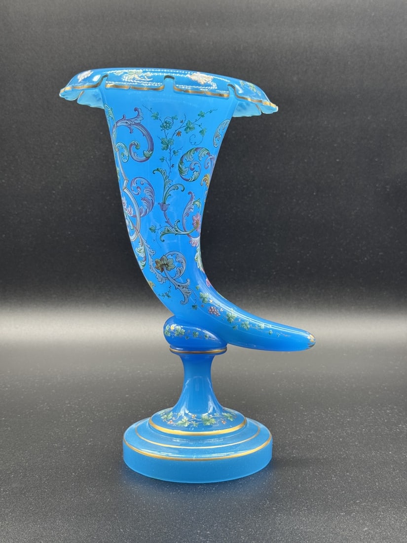 FRENCH TURQUOISE OPALINE GLASS ENAMELED CORNUCOPIA VASE, 19TH CENTURY: A magnificent centerpiece vase designed as a horn of plenty (cornucopia) in vibrant turquoise-blue opaline glass. The curved vessel features a ruffled, scalloped rim lined with gold leaf and rests on 