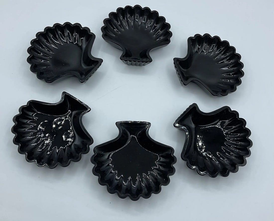 SET OF SIX BLACK GLASS SHELL-SHAPED DISHES, MANUFACTURED BY CRISTALLERIA VETRI (COSTA VETRI), ITALY,: A set of six dishes in opaque black glass, press-molded in the shape of a scallop shell with fluted radial ribs and a contoured outer rim.Italy (Cristalleria Vetri / Costa Vetri). Late 20th Century (c
