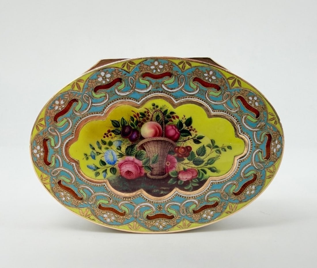 SWISS GOLD AND ENAMEL SNUFFBOX FOR THE OTTOMAN MARKET, GENEVA, CIRCA 1830: An oval gold snuffbox with polychrome enamel decoration. The cover features a central scalloped medallion hand-painted with a fruit basket and flower bouquet against a bright yellow background. The ce