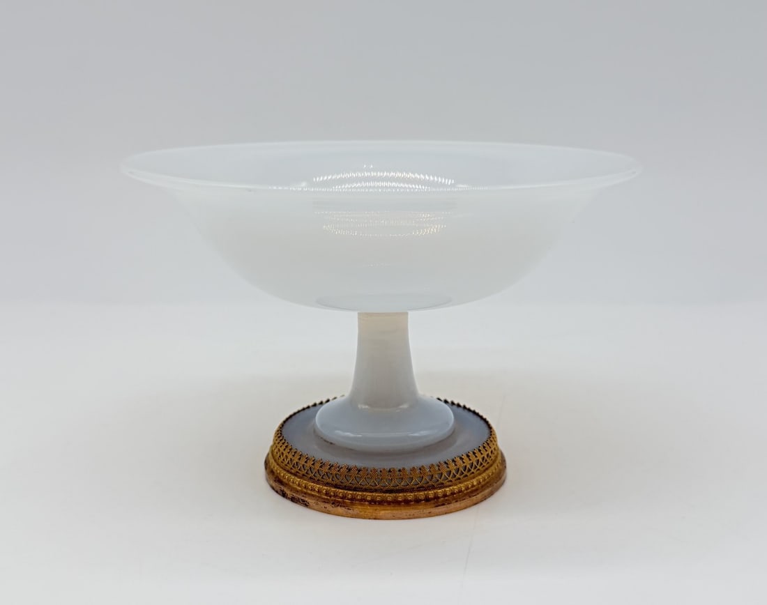 FRENCH "BULLE DE SAVON" OPALINE GLASS FOOTED TAZZA WITH GILT-BRONZE MOUNT, CHARLES X PERIOD: A shallow, wide-rimmed tazza or coupe crafted in semi-translucent, iridescent "bulle de savon" (soap bubble) opaline glass. The delicate bowl rests on a slender turned pedestal stem and a flared circu
