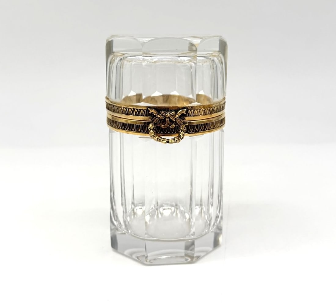Baccarat Octagonal Cut Crystal Covered Scent Bottle: BACCARAT. Octagonal-shaped bottle or case made of moulded and cut crystal with bevelled edges, set in a guilloché gilt-bronze mount, opening with a clasp adorned with an eyelet.France. Napoleonic III
