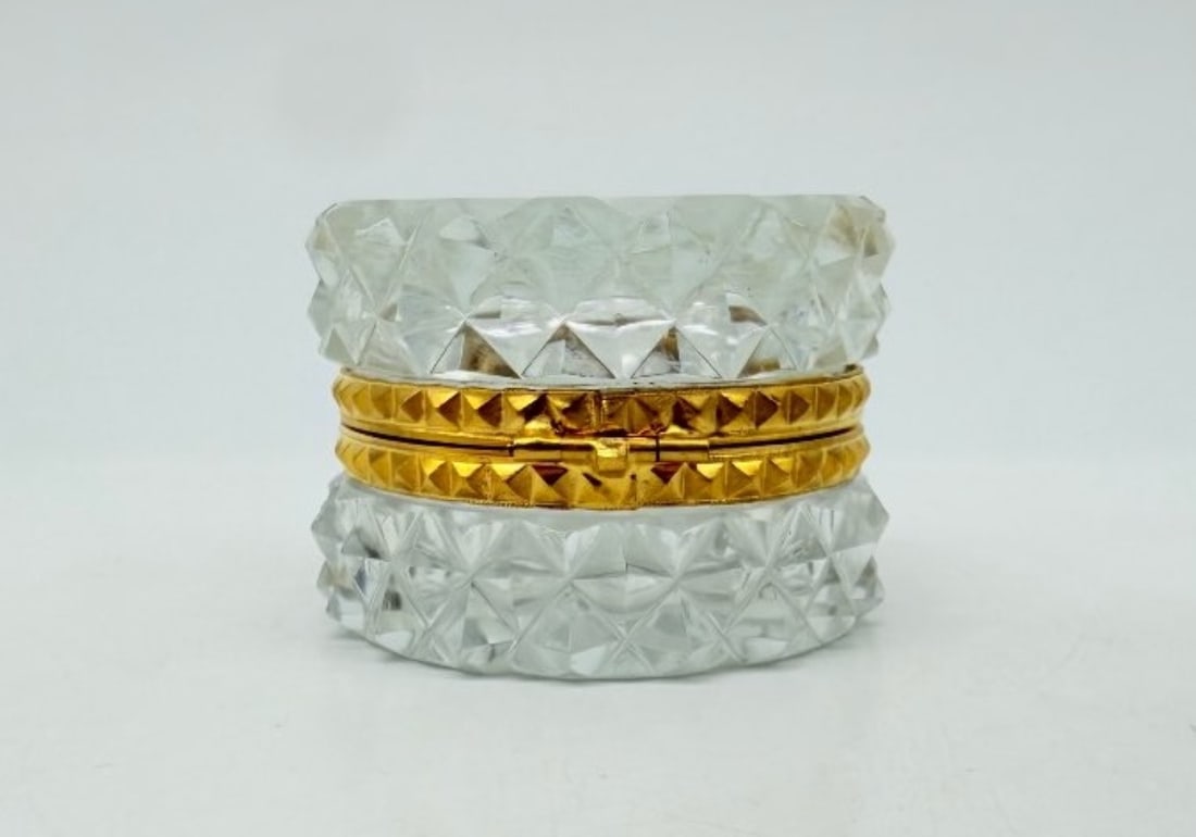 Cut Crystal And Gilt Bronze Covered Box, Late 19th Century: A small, lidded, cylindrical box made of diamond-cut crystal, with a gilded bronze mount chased with a guilloché frieze.France. Late 19th century.H_4.5 cm W_6.5 cmVery good condition.