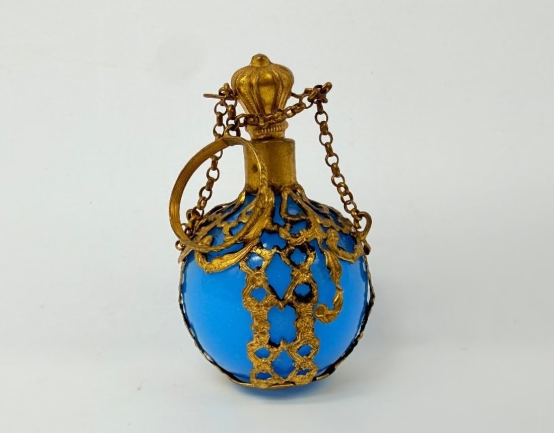 Turquoise Blue Opaline Pocket Scent Bottle With Gilt Cage Mount, Napoleon III Period: A spherical Pocket Scent Bottle in turquoise-blue opaline glass, set within a gilded brass cage-like frame, pierced and chiselled with a decoration of foliage scrolls, latticework and rocaille volutes