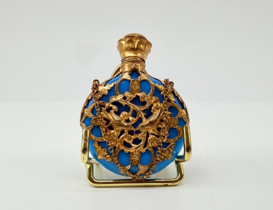 Rare Turquoise Blue Opaline Pocket Scent Bottle With Gilt Cage Mount, Napoleon III Period: A circular, flattened pocket perfume bottle in turquoise-blue opaline glass, encased in a substantial cage-like mount of gilded brass (or gilded metal), re-pierced and chiselled with a decoration of r