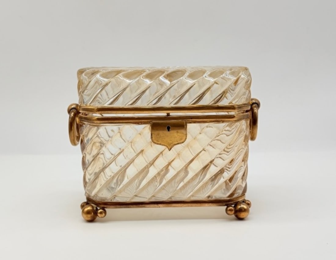 LARGE FRENCH CUT CRYSTAL CASKET BOX WITH GILT-BRONZE MOUNTS,BACCARAT, NAPOLEON III PERIOD: A large rectangular clear crystal casket box featuring heavy spiral-twisted (bambous / torsades) molded glass ribs. The box is fitted with gilt-bronze (ormolu) mounts including a hinged rim, central e