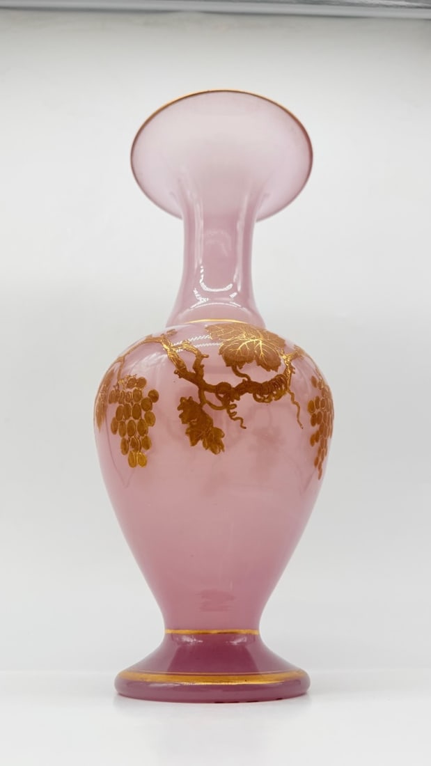 FRENCH PINK OPALINE GLASS VASE WITH GILDED VINE DECORATION, 19TH CENTURY: A large baluster-shaped vase crafted in soft pink opaline glass featuring a wide, flared trumpet rim and a spreading circular pedestal foot. The central bulbous body is hand-painted in rich gold ename
