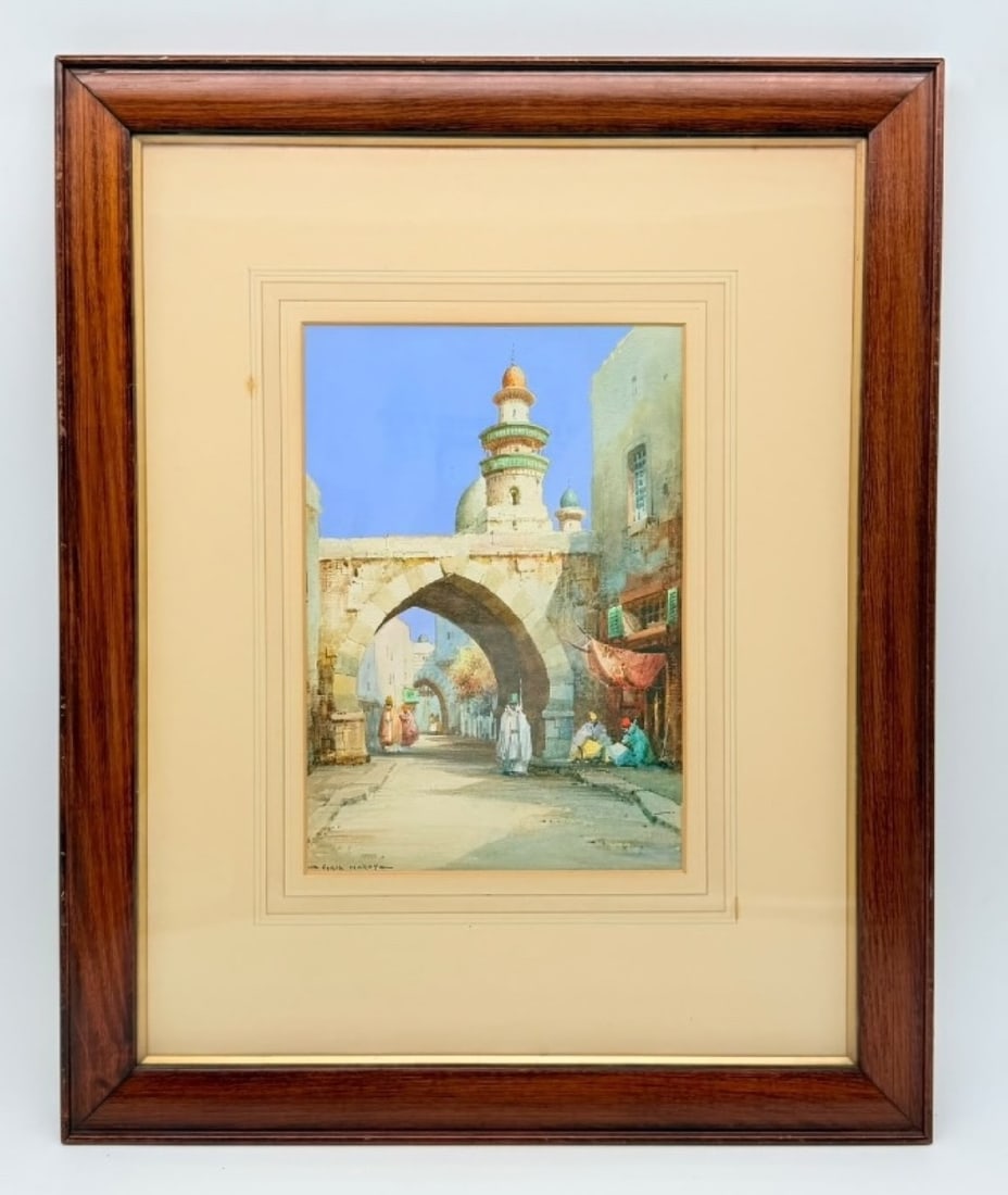 NOEL HARRY LEAVER (1889–1951), A Street Scene in Algiers with Minaret and Archway, Watercolor on: Noel Harry LEAVER (1889; 1951).A bustling alleyway in Algiers.Watercolour.Signed.Framed under glass.H_28 cm ; W_20 cmThis watercolor presents a sunlit alleyway in Algiers, framed by a stone archway le