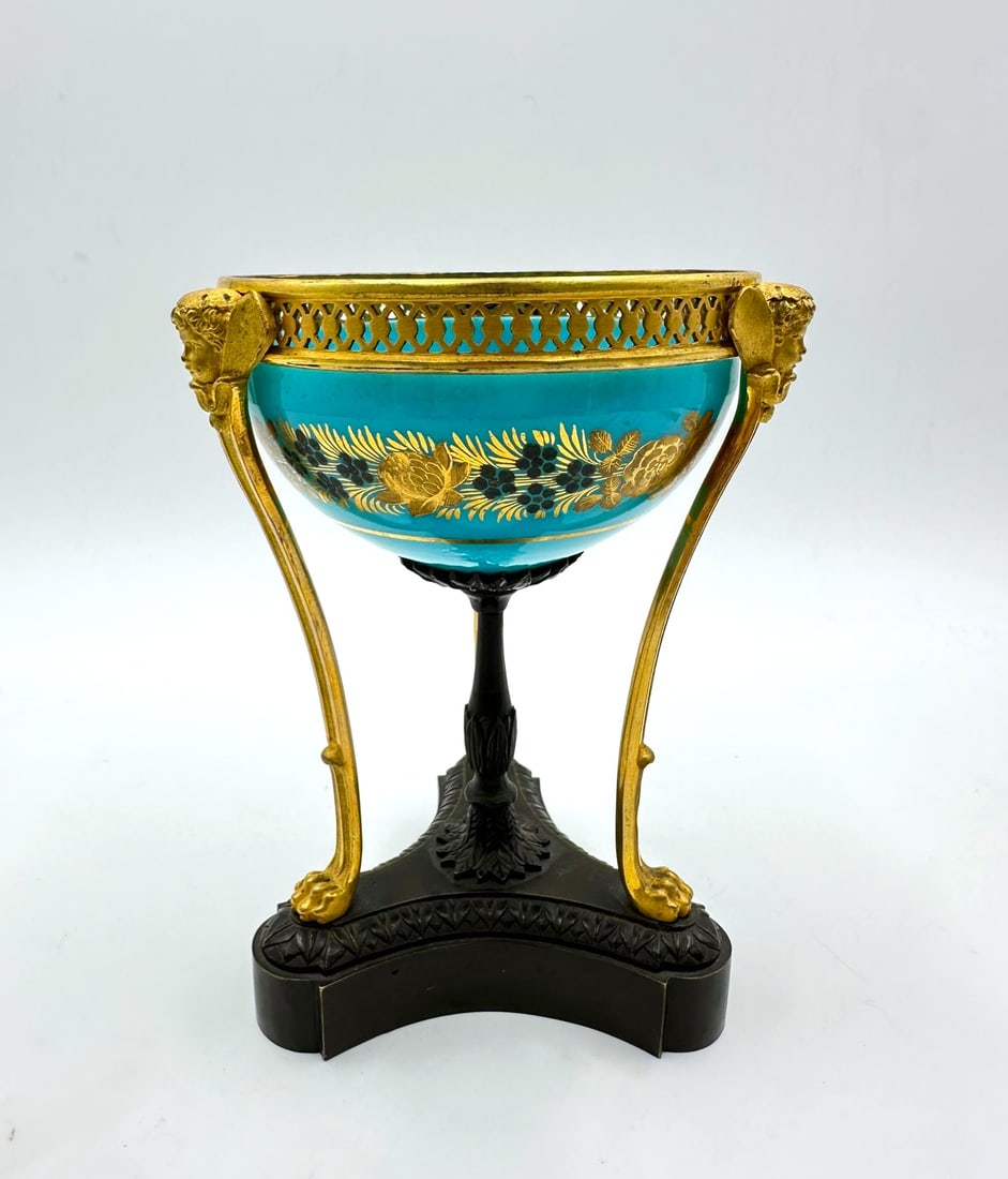 FRENCH TURQUOISE OPALINE GLASS AND GILT-BRONZE TRIPOD BOWL, CHARLES X PERIOD: A turquoise opaline glass bowl resting on a patinated and gilt-bronze tripod mount. The exterior of the glass is embellished with fine gilt and silver Desvignes-style decoration displaying a continuou
