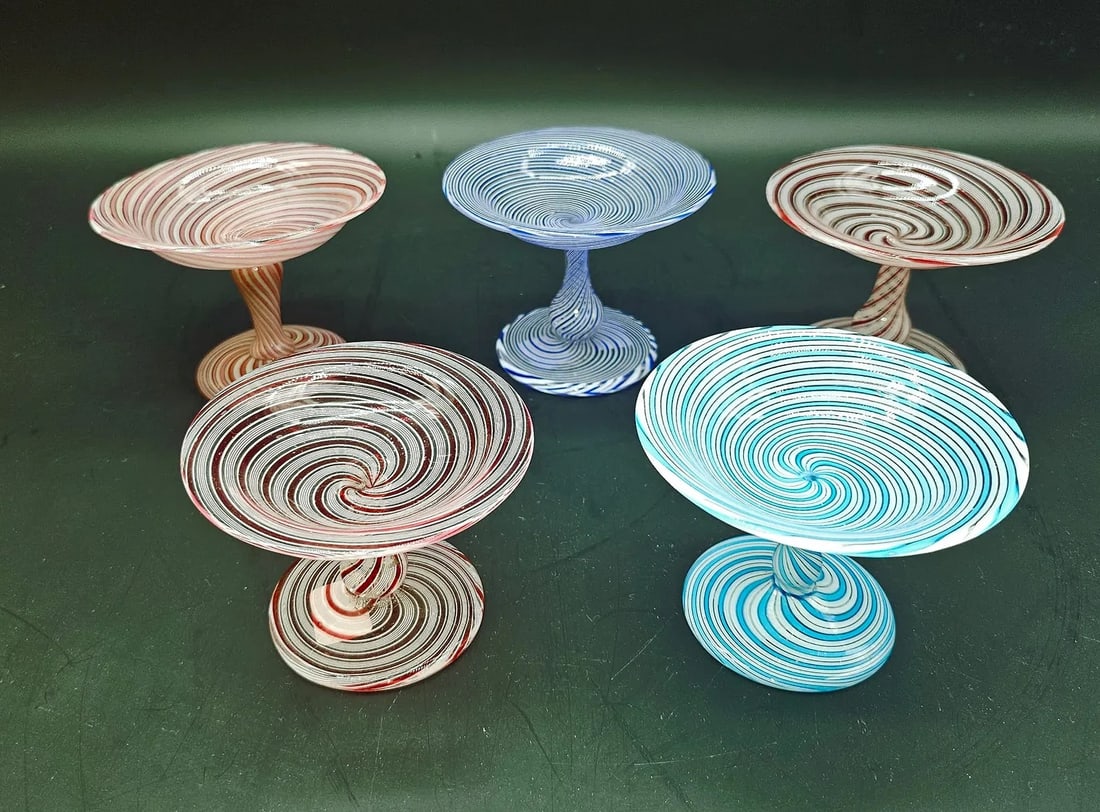 SET OF FIVE FRENCH FILIGREE GLASS SMALL TAZZAS (BAGUIERS), BACCARAT AND CLICHY, MID-19TH CENTURY: Set of five footed small tazzas crafted in spiraled colored glass and opaque white filigree, each raised on a twisted baluster stem and circular foot.France (Baccarat and Clichy factories). Mid-19th C